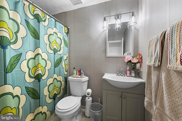 a view of a backyard with plants and wooden fence