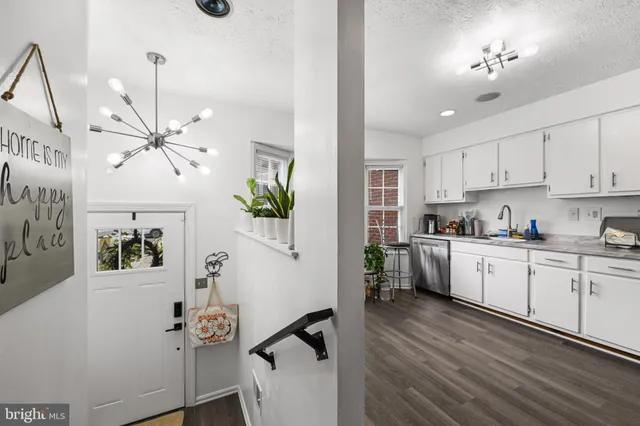 a kitchen with cabinets a sink and appliances