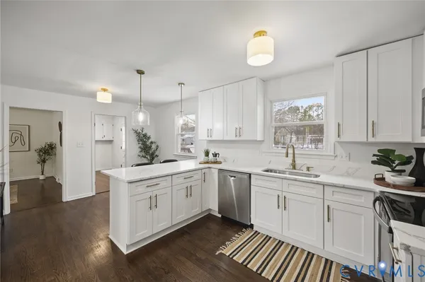 a kitchen with a sink stove and cabinets