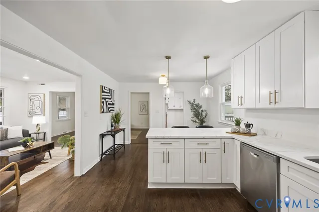 a kitchen with white cabinets and sink