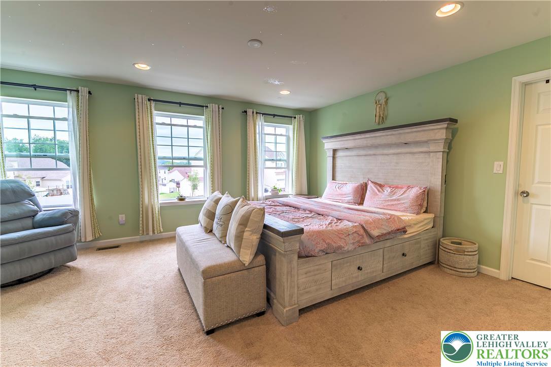 3892 Mink Road Emmaus, PA 18049 - Photo 19 of 39 a bedroom with a bed couch and windows
