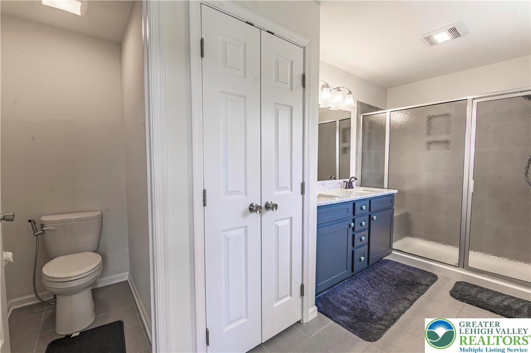 3892 Mink Road Emmaus, PA 18049 - Photo 21 of 39 a bathroom with a granite countertop sink a toilet and a shower