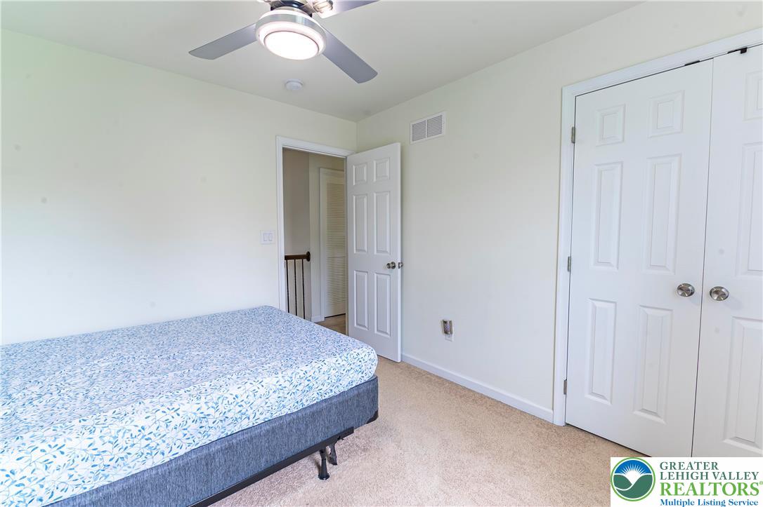 3892 Mink Road Emmaus, PA 18049 - Photo 23 of 39 a bedroom with a bed and a chandelier