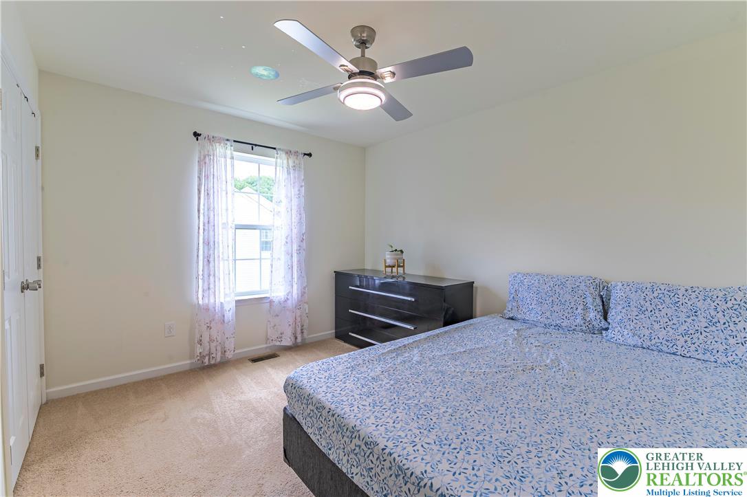 3892 Mink Road Emmaus, PA 18049 - Photo 24 of 39 a bedroom with a bed and a ceiling fan