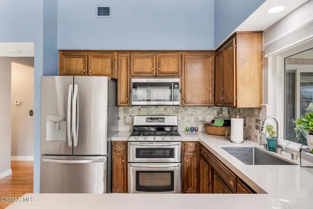 a kitchen with a refrigerator and a sink