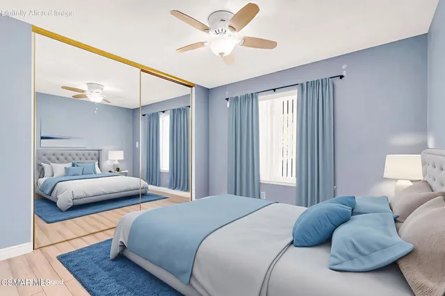 a bedroom with two beds and painting on the wall