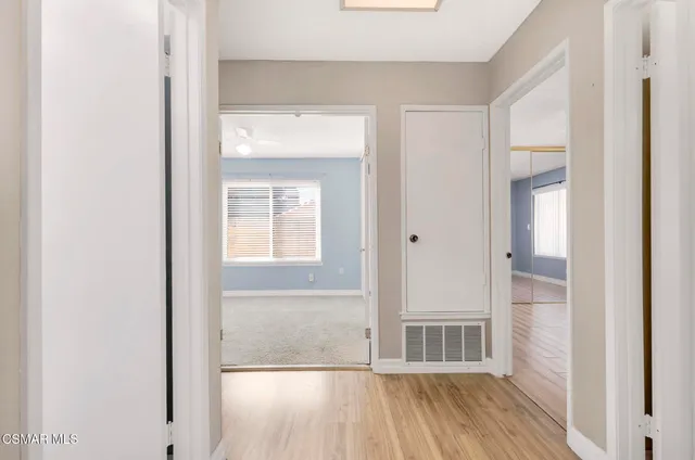 a view of a small space with wooden floor and a window