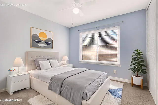 a bedroom with a bed and a painting on the wall