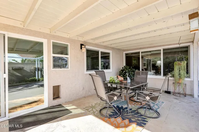 a view of a patio with table and chairs and potted plants