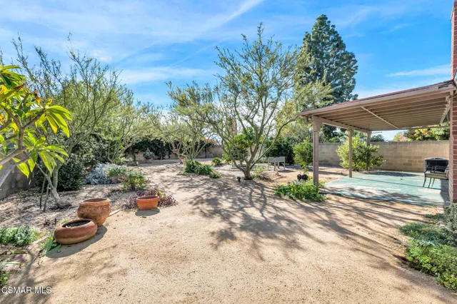 a view of backyard with outdoor and green space