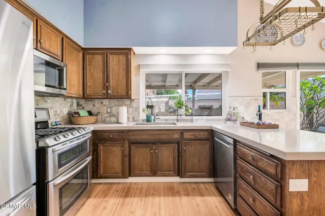 a kitchen with stainless steel appliances granite countertop a stove and a sink