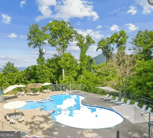 an aerial view of a house with a yard and lake view