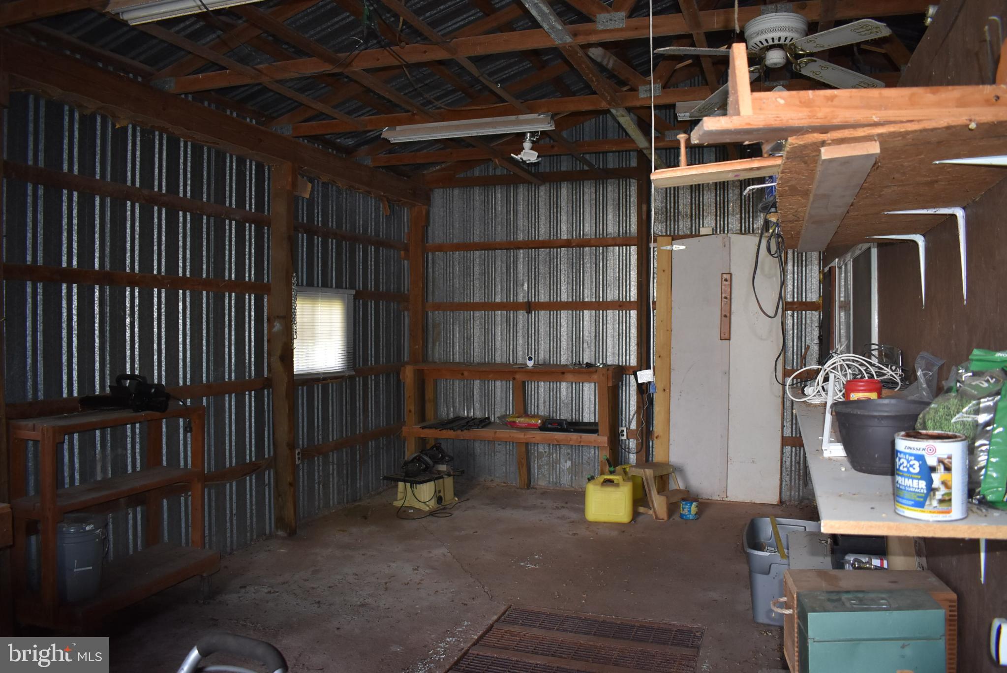 1971 Duckwall Road Berkeley Springs, WV 25411 - Photo 19 of 64 Rustic workshop with metal walls and shelves.