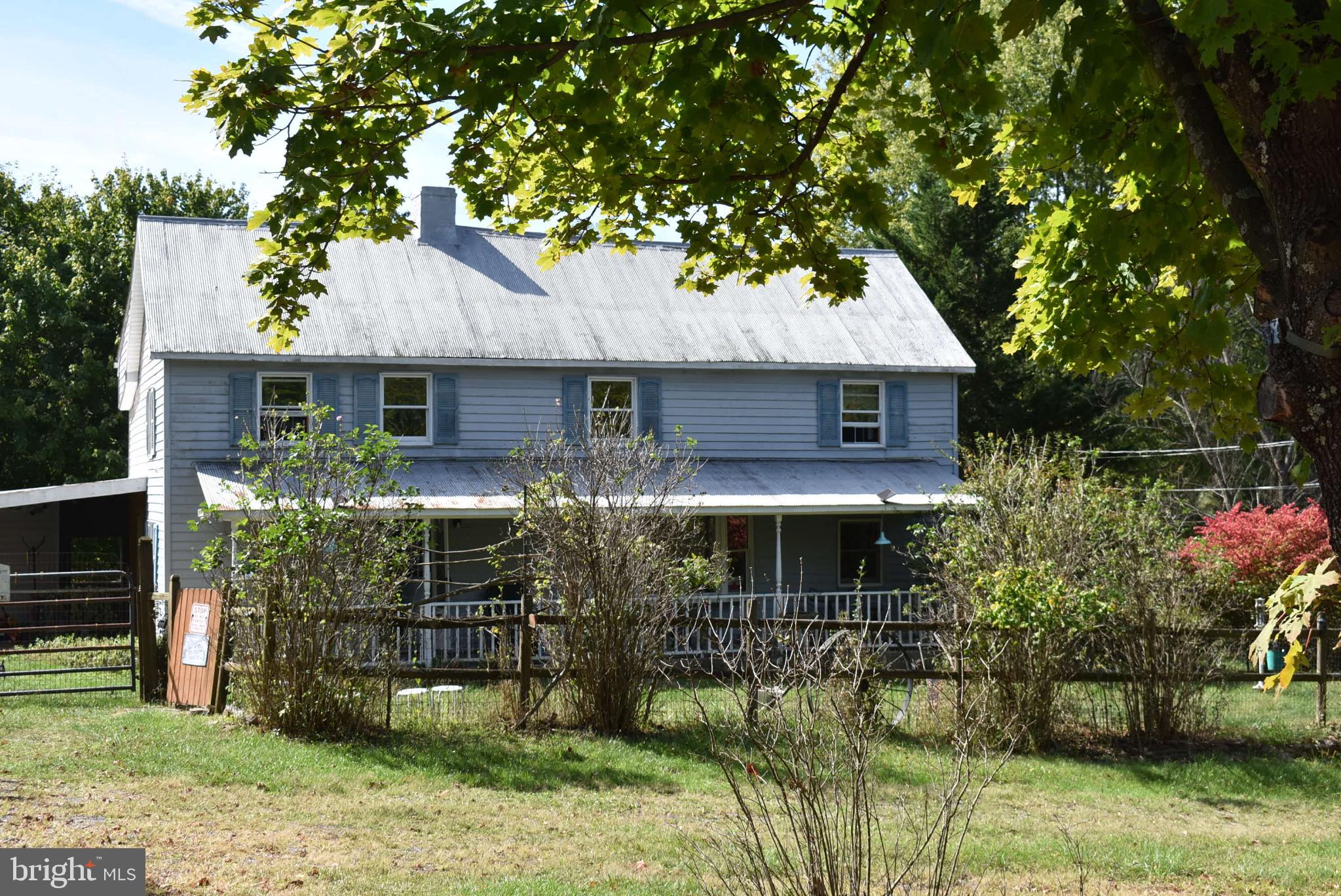 1971 Duckwall Road Berkeley Springs, WV 25411 - Photo 2 of 64 a front view of a house with garden