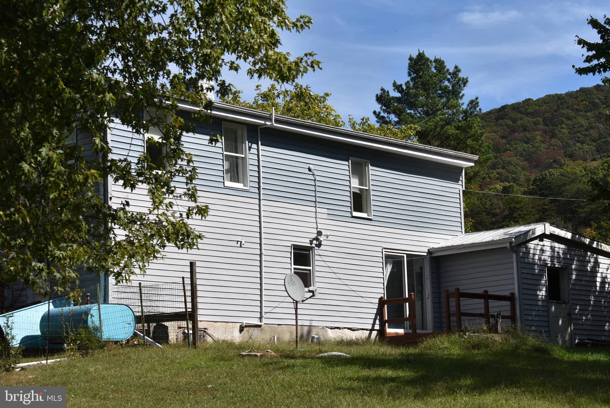 1971 Duckwall Road Berkeley Springs, WV 25411 - Photo 27 of 64 a view of house with a yard and a large tree