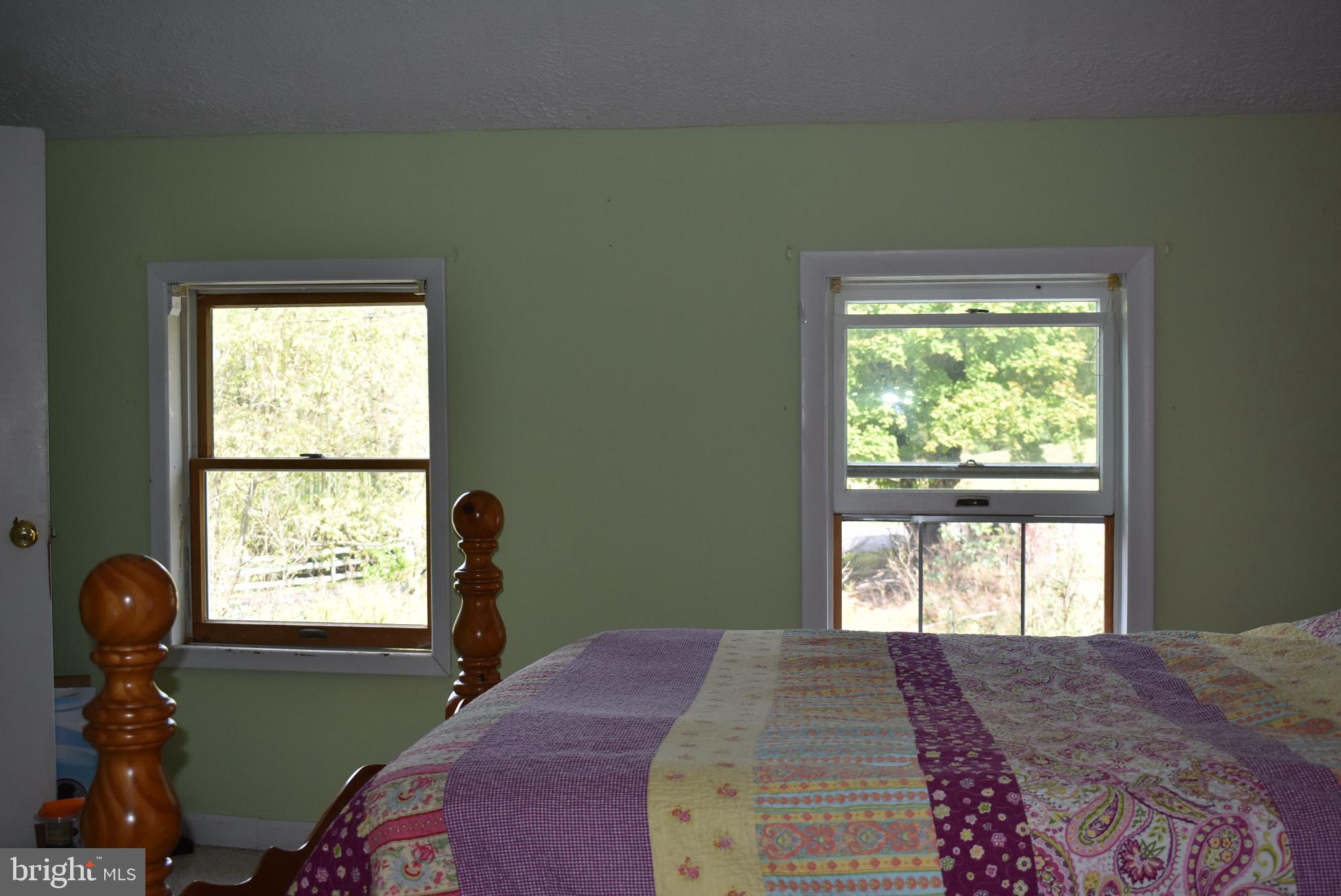 1971 Duckwall Road Berkeley Springs, WV 25411 - Photo 45 of 64 a bedroom with a bed and a large window