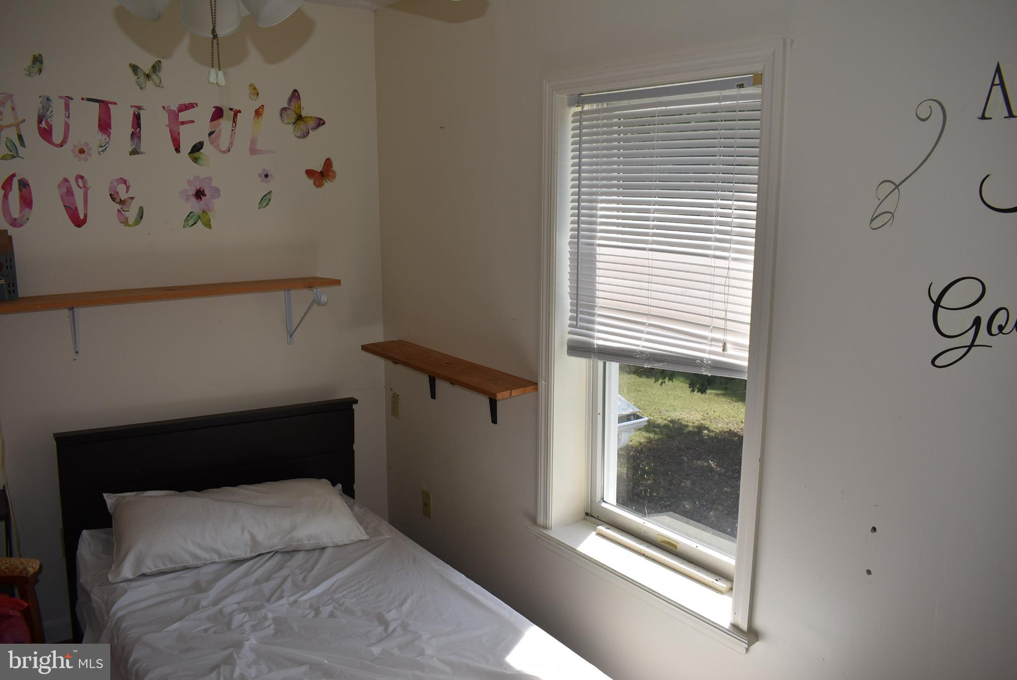 1971 Duckwall Road Berkeley Springs, WV 25411 - Photo 46 of 64 a bedroom with a bed and a window