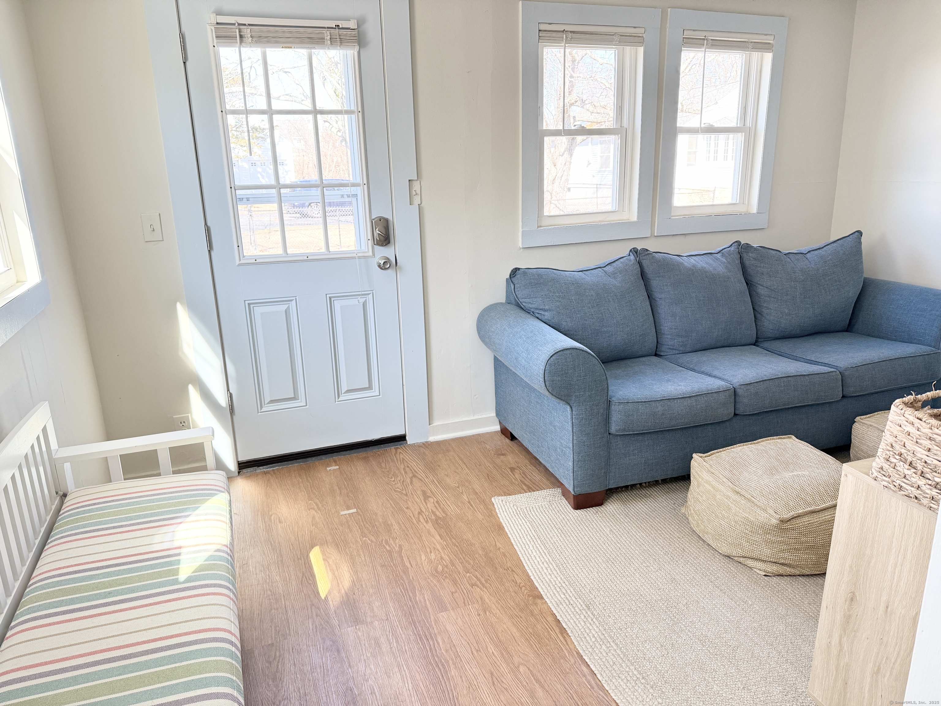 102 Chalker Beach Road Old Saybrook, CT 06475 - Photo 11 of 22 a living room with furniture and a window