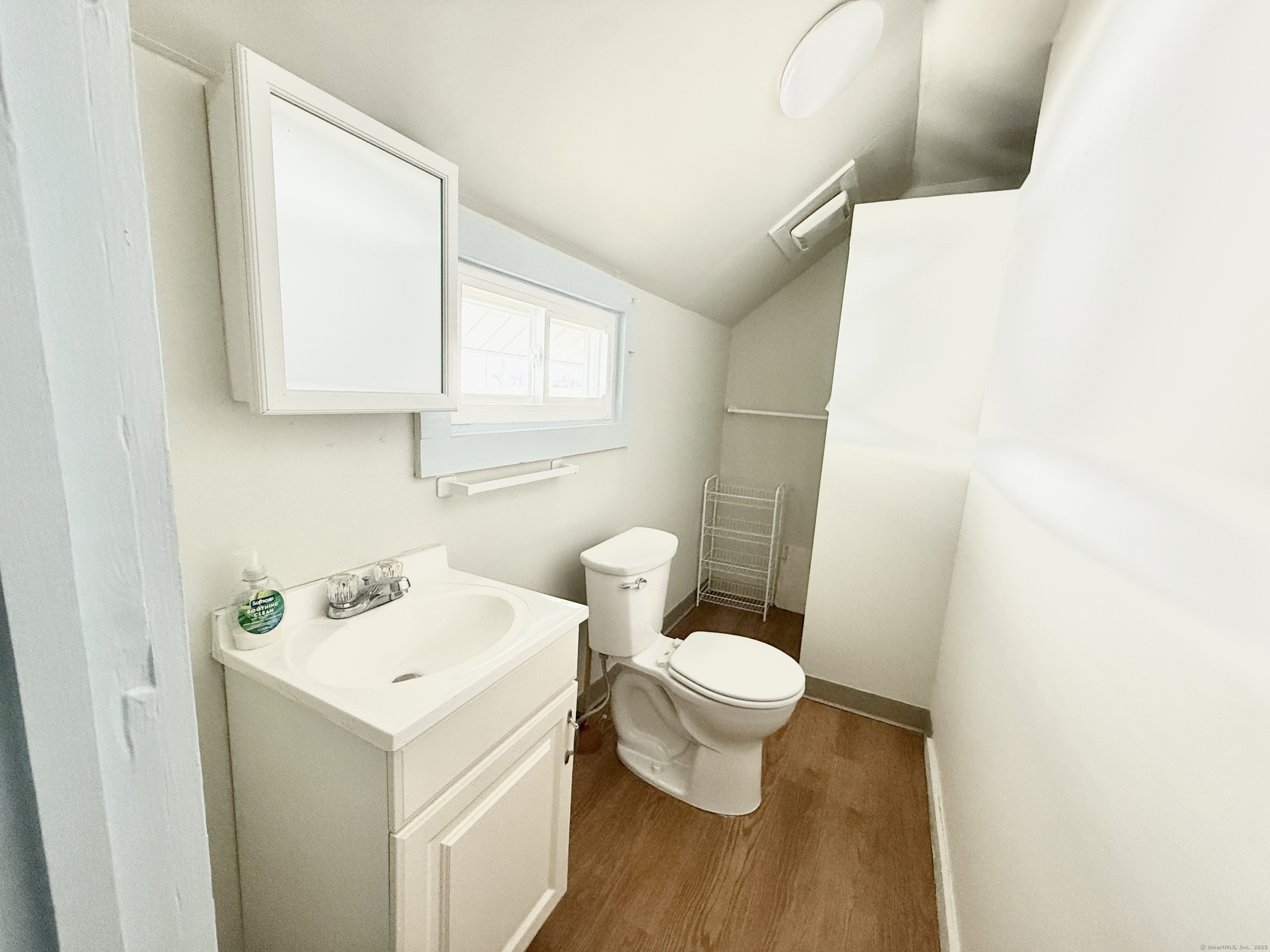 102 Chalker Beach Road Old Saybrook, CT 06475 - Photo 18 of 22 a bathroom with a sink a toilet and a mirror