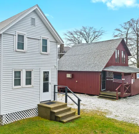 a backyard of a house with barbeque oven table and chairs