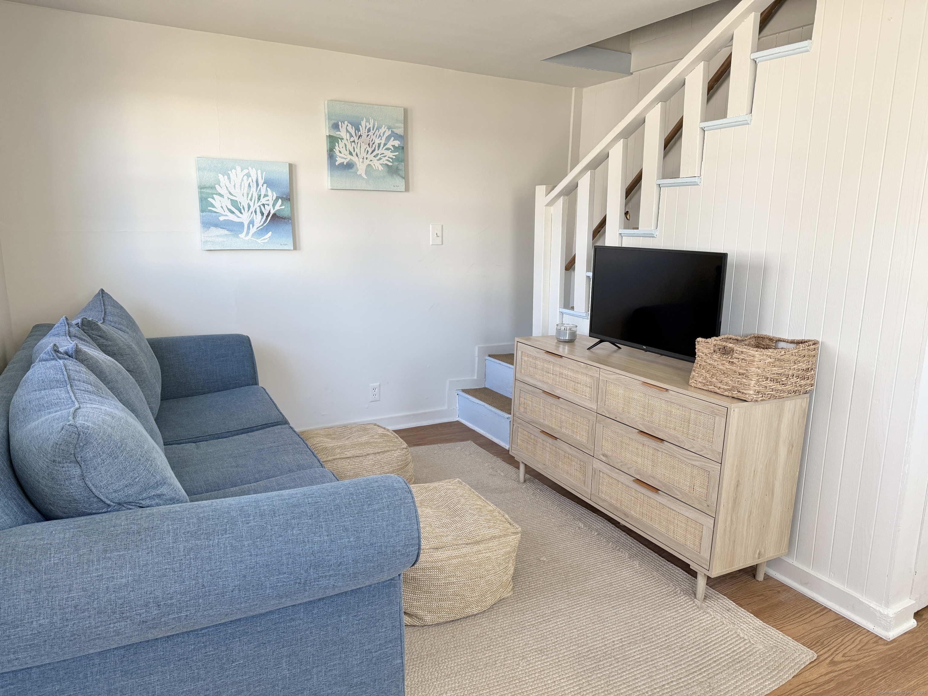 102 Chalker Beach Road Old Saybrook, CT 06475 - Photo 6 of 22 a living room with furniture and a fireplace