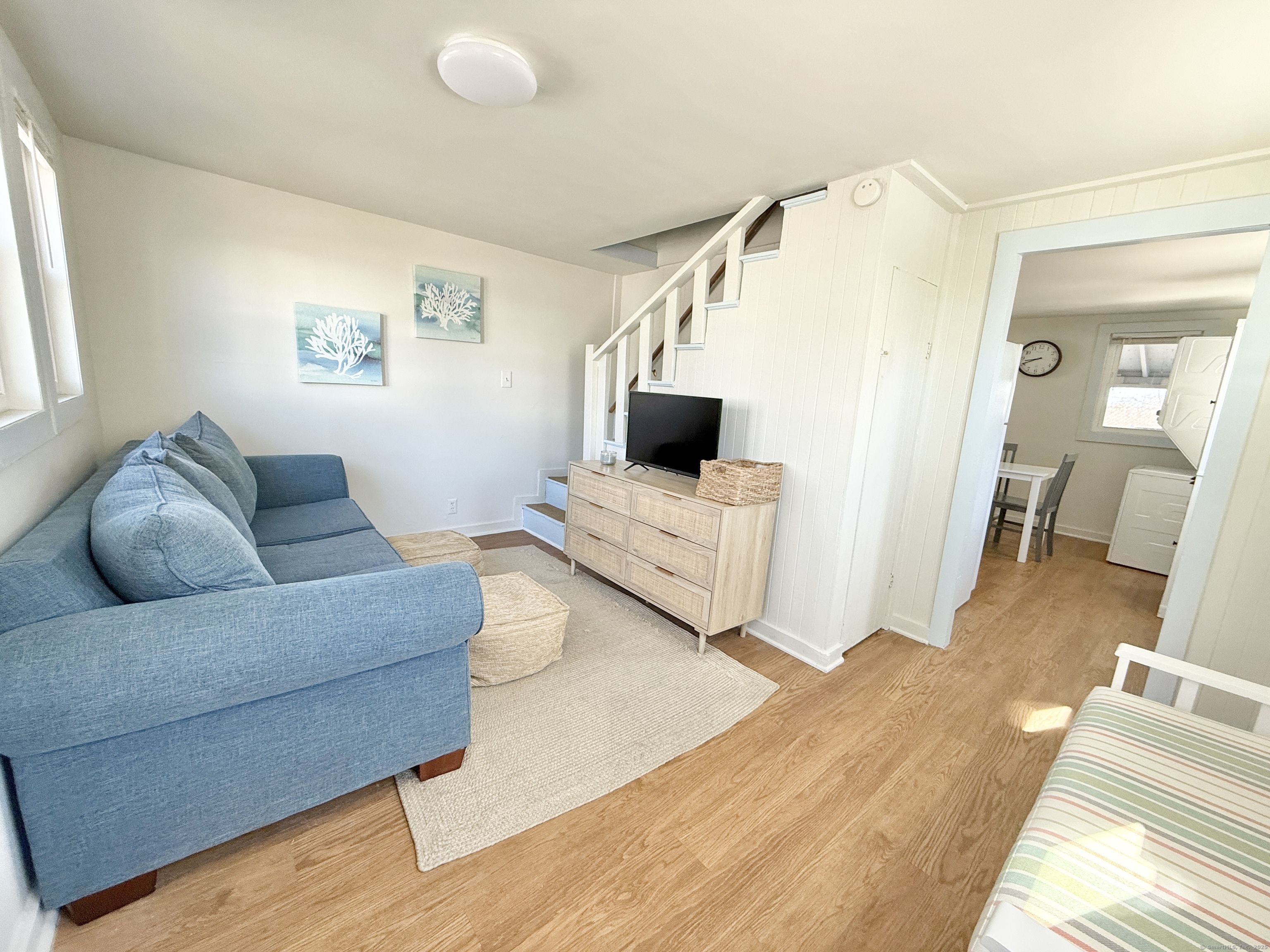 102 Chalker Beach Road Old Saybrook, CT 06475 - Photo 7 of 22 a living room with furniture and a flat screen tv
