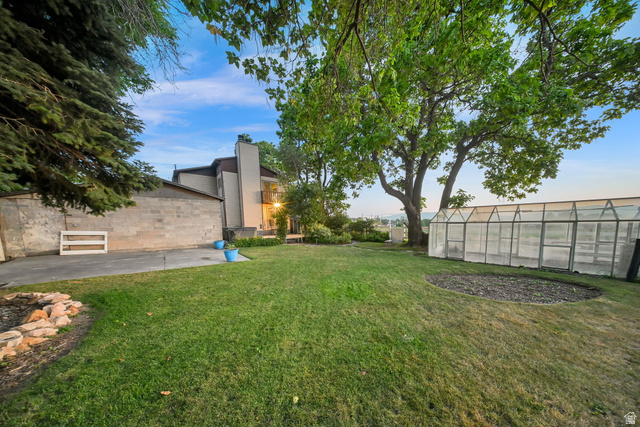 374 West Lakeview Road Lindon, UT 84042 - Photo 9 of 44 Expansive green lawn with mature trees and a large greenhouse structure