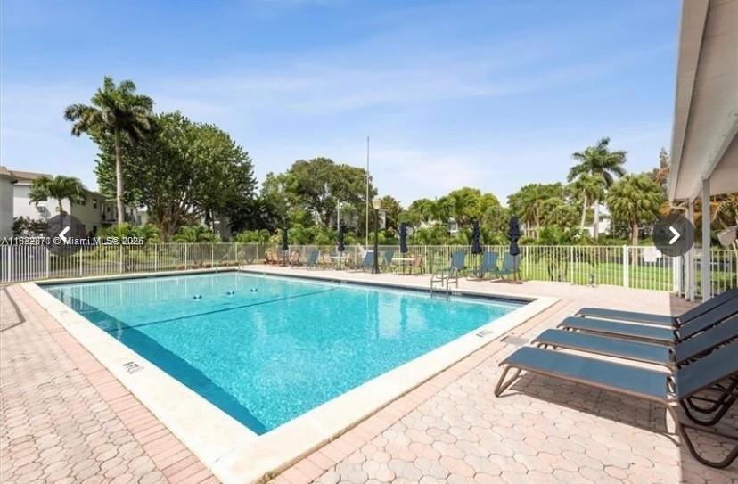 1125 Southeast 14th Place, Unit 21C Fort Lauderdale, FL 33316 - Photo 12 of 18 a view of a swimming pool with a patio