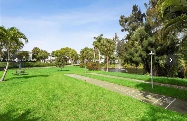 a garden with trees in front of it