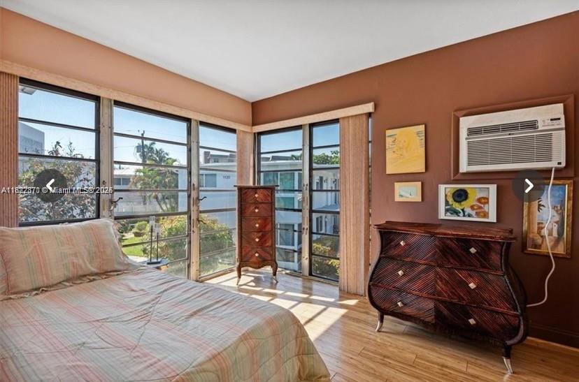 1125 Southeast 14th Place, Unit 21C Fort Lauderdale, FL 33316 - Photo 8 of 18 a bedroom with a bed and wooden floor