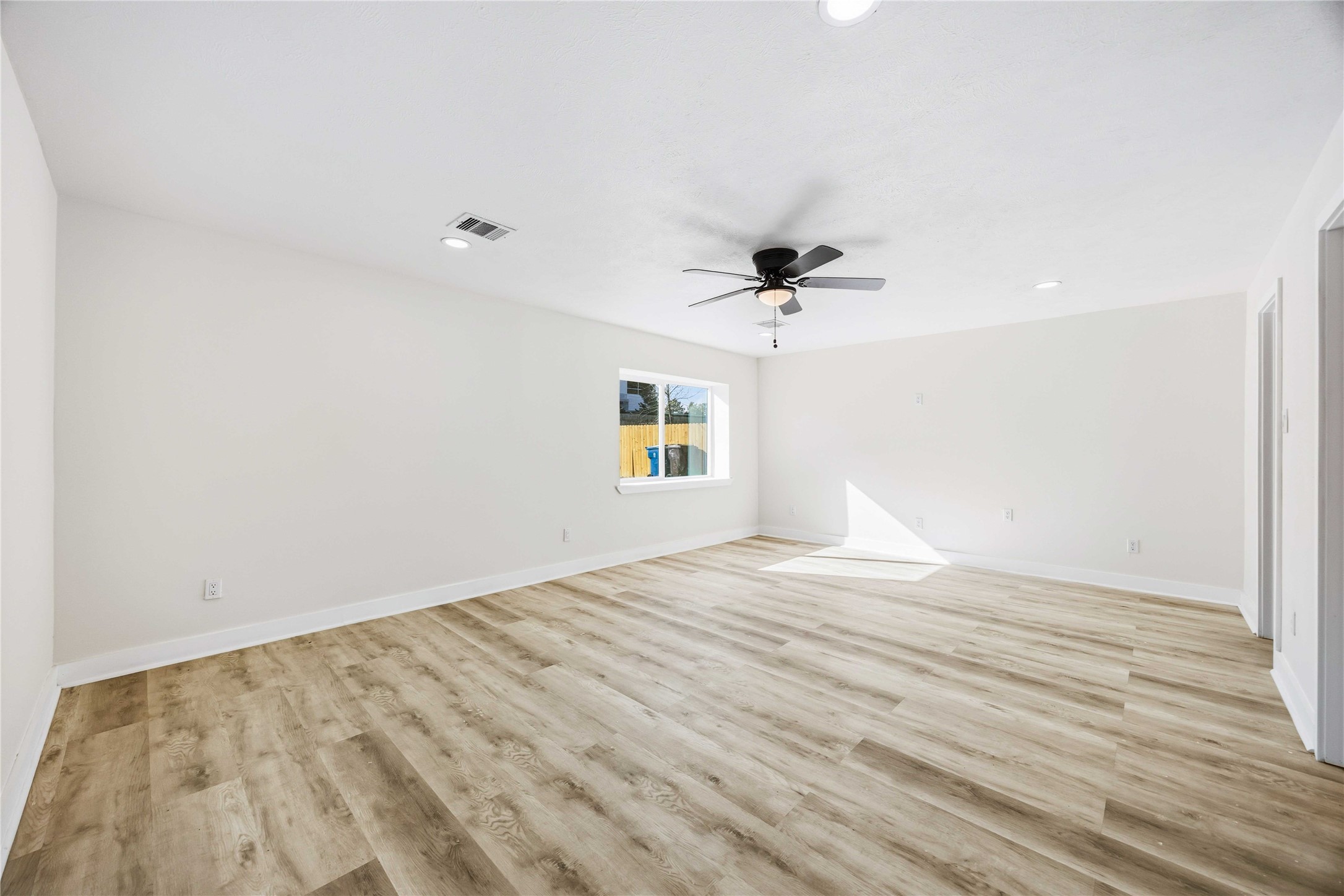18234 Atkinson Lane Conroe, TX 77384 - Photo 12 of 30 a view of empty room with wooden floor and fan