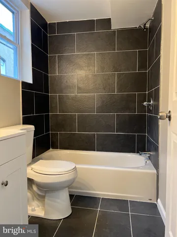 a bathroom with a toilet and blue walls