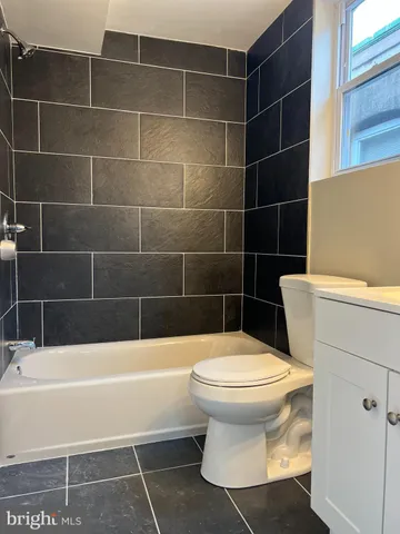 a bathroom with a toilet and a bathtub