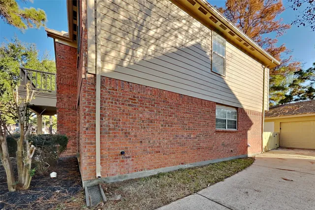 a view of a brick house with a yard