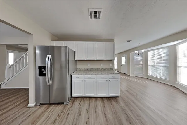 a kitchen with stainless steel appliances a refrigerator sink and cabinets