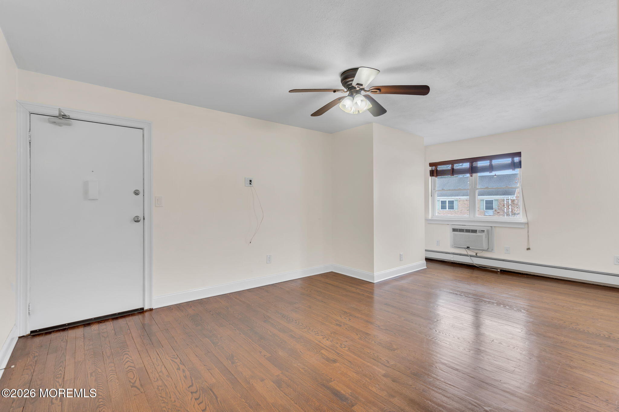 26 Windsor Terrace, Unit E Freehold, NJ 07728 - Photo 1 of 20 a view of empty room with wooden floor and fan