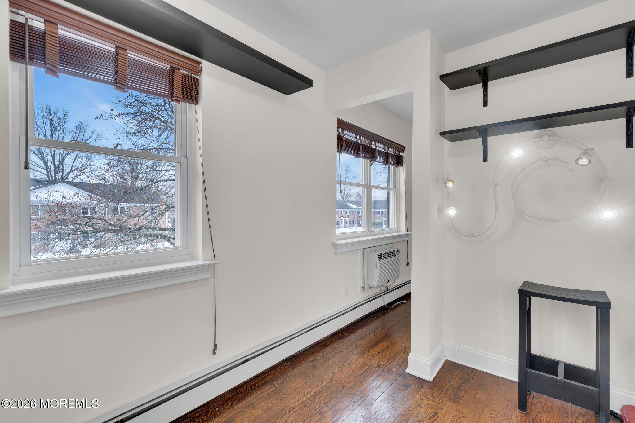 26 Windsor Terrace, Unit E Freehold, NJ 07728 - Photo 12 of 20 a view of an empty room with wooden floor and a window