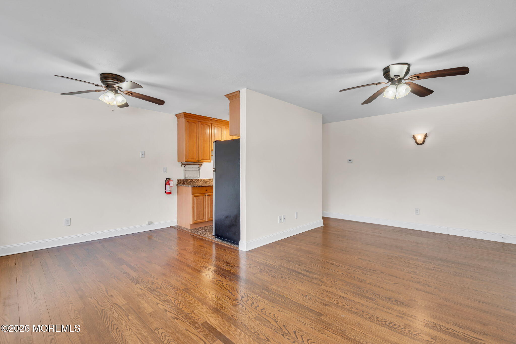 26 Windsor Terrace, Unit E Freehold, NJ 07728 - Photo 4 of 20 wooden floor in an empty room with a window