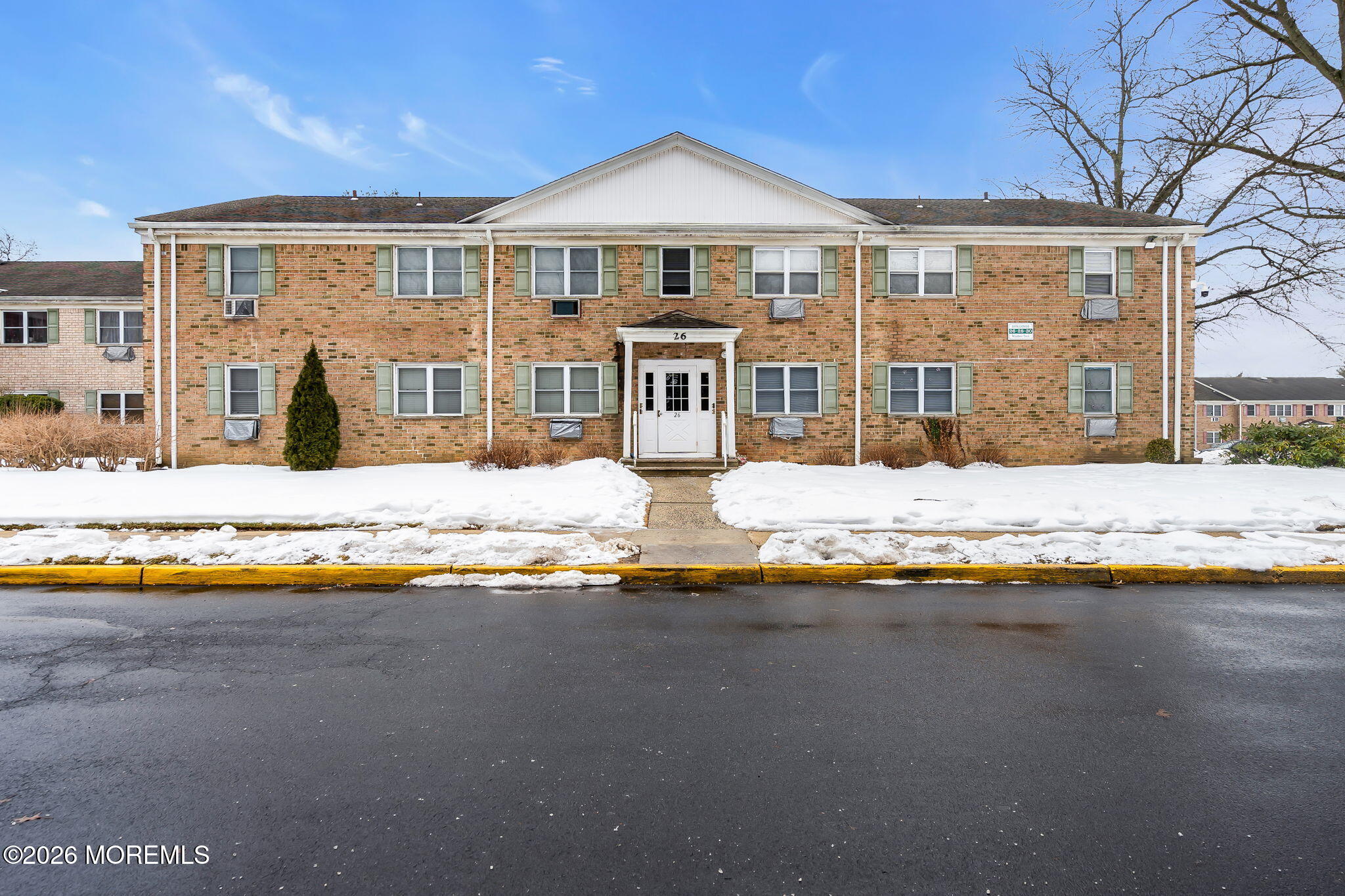 26 Windsor Terrace, Unit E Freehold, NJ 07728 - Photo 7 of 20 a front view of a house with a yard