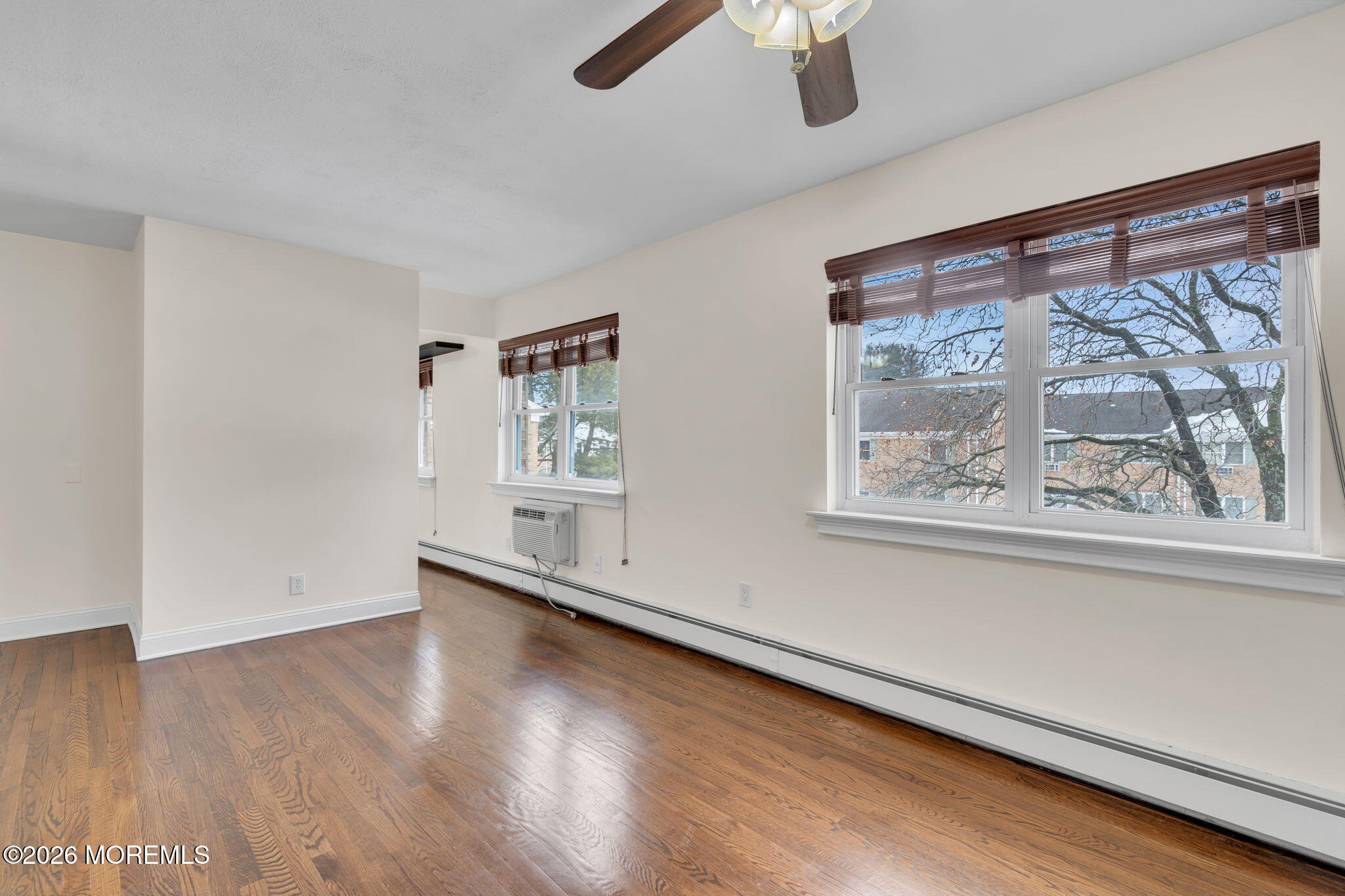 26 Windsor Terrace, Unit E Freehold, NJ 07728 - Photo 9 of 20 wooden floor in an empty room with a window
