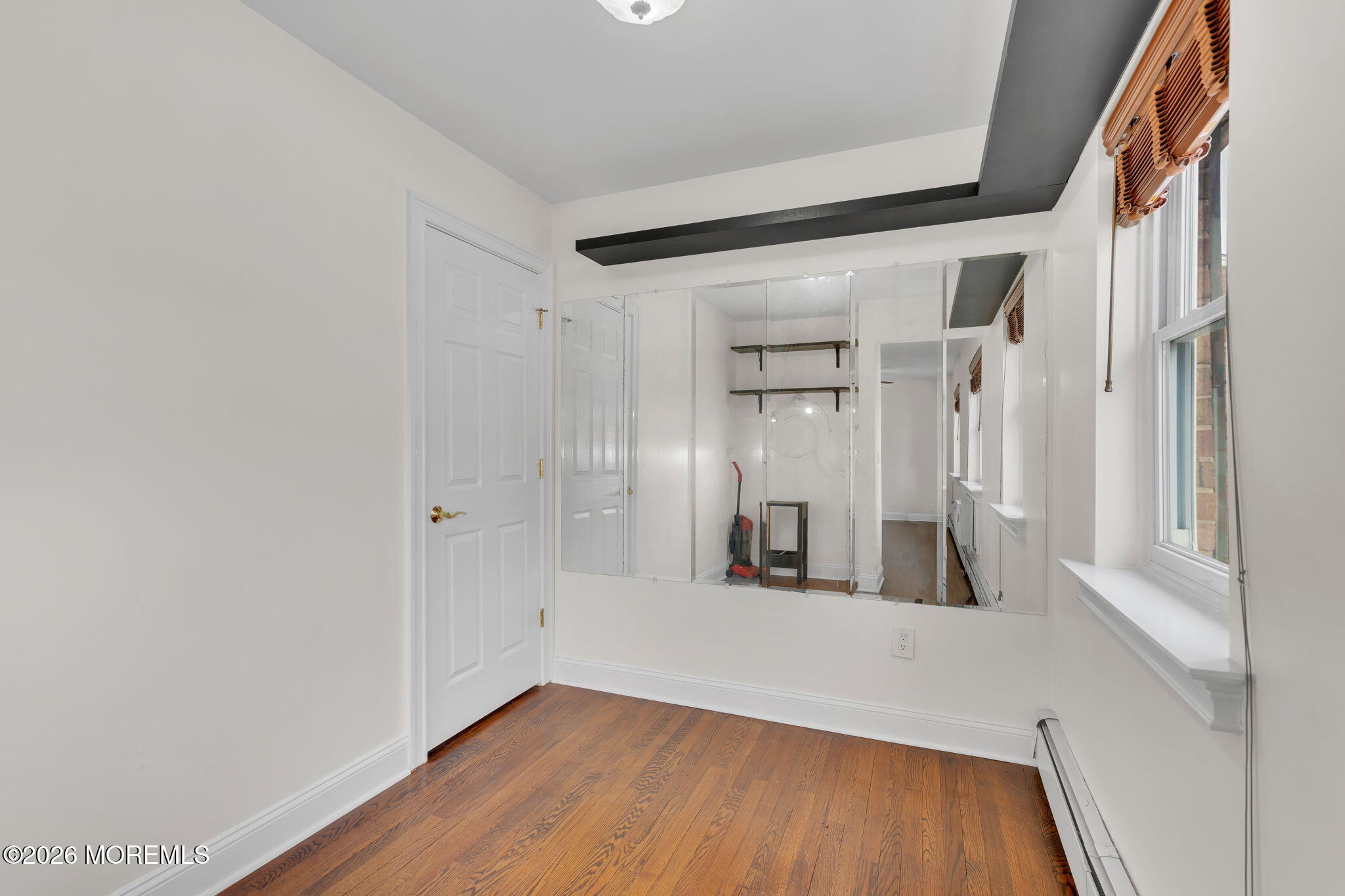 26 Windsor Terrace, Unit E Freehold, NJ 07728 - Photo 10 of 20 a view of empty room with wooden floor
