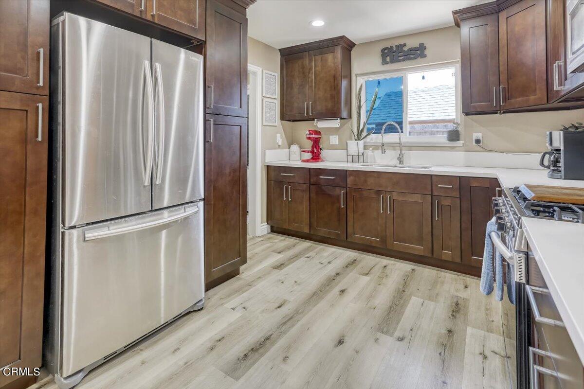 635 Oleander Drive Oxnard, CA 93033 - Photo 11 of 37 a kitchen with kitchen island a sink appliances and cabinets