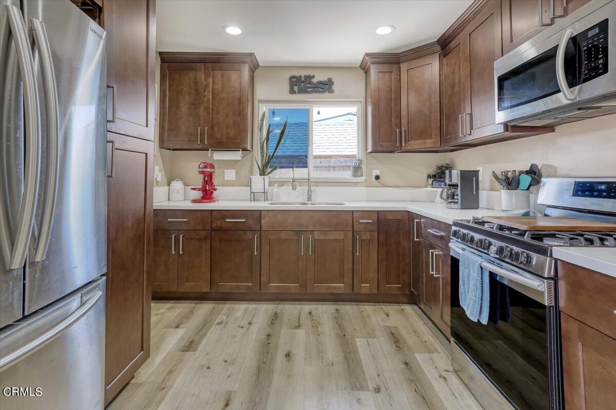 635 Oleander Drive Oxnard, CA 93033 - Photo 12 of 37 a kitchen with stainless steel appliances granite countertop a stove sink and refrigerator