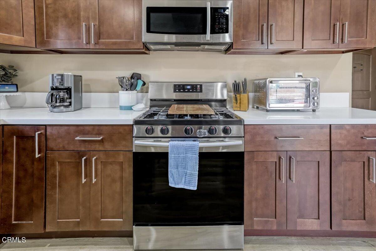 635 Oleander Drive Oxnard, CA 93033 - Photo 13 of 37 a kitchen with stainless steel appliances granite countertop a stove and a microwave