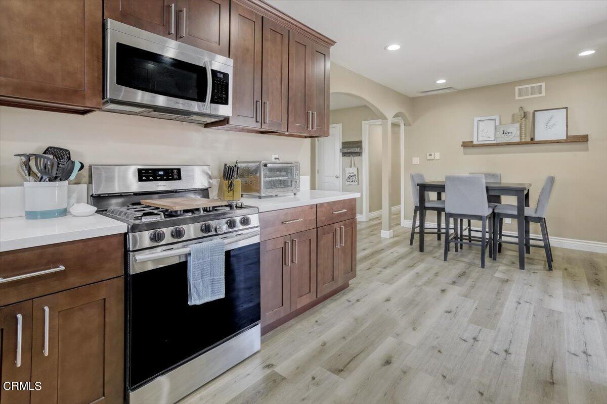 635 Oleander Drive Oxnard, CA 93033 - Photo 14 of 37 a kitchen with stainless steel appliances a stove a sink a microwave and cabinets