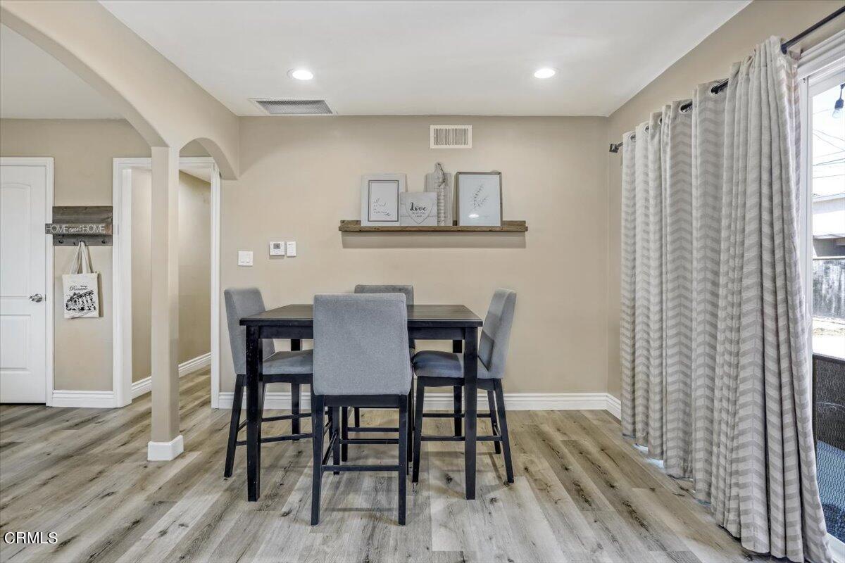 635 Oleander Drive Oxnard, CA 93033 - Photo 17 of 37 a view of a dining room with furniture and wooden floor