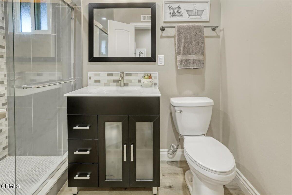 635 Oleander Drive Oxnard, CA 93033 - Photo 23 of 37 a bathroom with a toilet sink and mirror