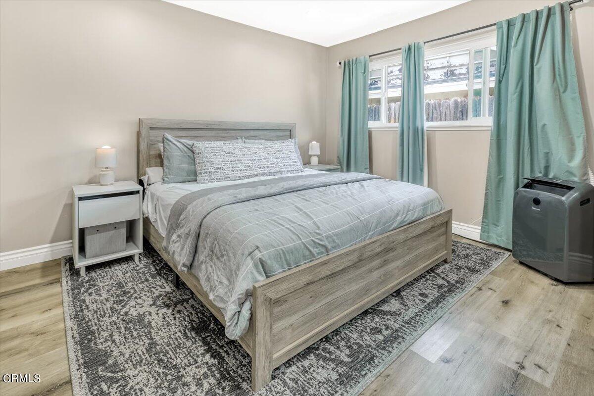 635 Oleander Drive Oxnard, CA 93033 - Photo 26 of 37 a bedroom with a bed lamp and a large window