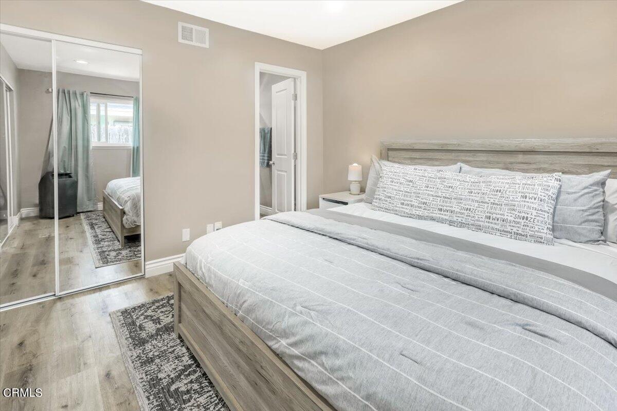 635 Oleander Drive Oxnard, CA 93033 - Photo 27 of 37 a spacious bedroom with a bed and wooden floor
