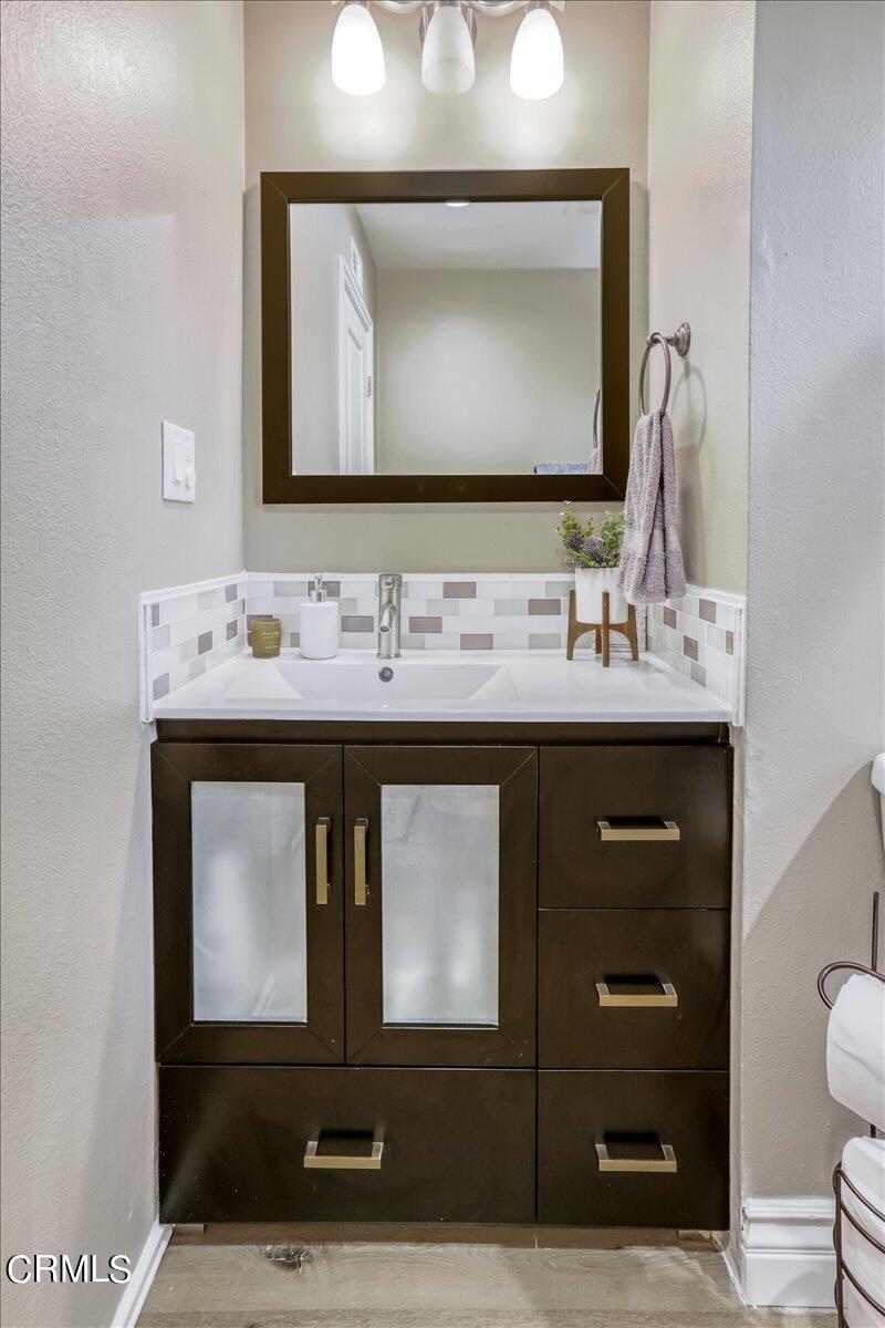 635 Oleander Drive Oxnard, CA 93033 - Photo 29 of 37 a bathroom with a toilet sink and mirror